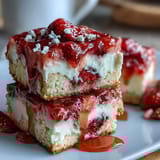 Vibrant strawberry lemonade bars with buttery shortbread crust, dusted with powdered sugar and perfect for summer parties.