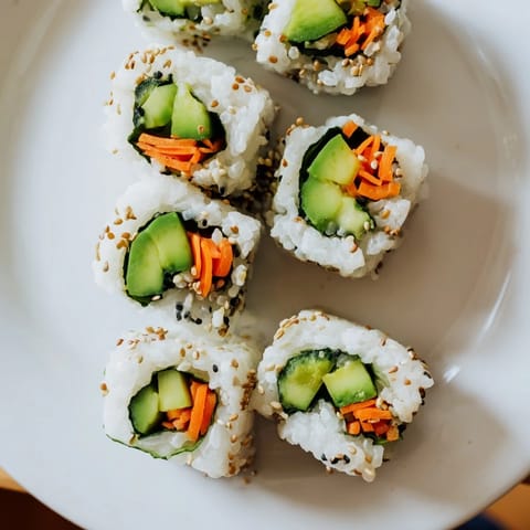 A close-up of beautifully rolled Avocado Cucumber Sushi, showcasing the creamy avocado and crisp cucumber inside.