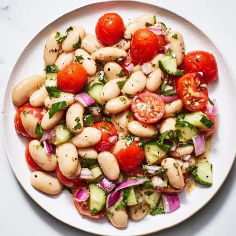 This delicious white bean salad showcases creamy beans and colorful vegetables ready to enjoy.
