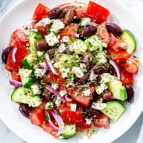 Freshly tossed Mediterranean Salad, a colorful mix of vegetables and feta ready to serve.