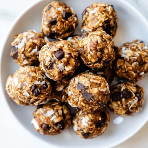 Close-up of chewy Almond-Chia Energy Bites speckled with chocolate chips, an easy no-bake treat.