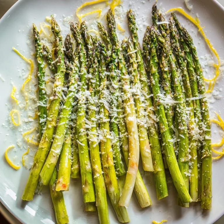Freshly roasted asparagus with Parmesan, a squeeze of lemon and parsley garnish.