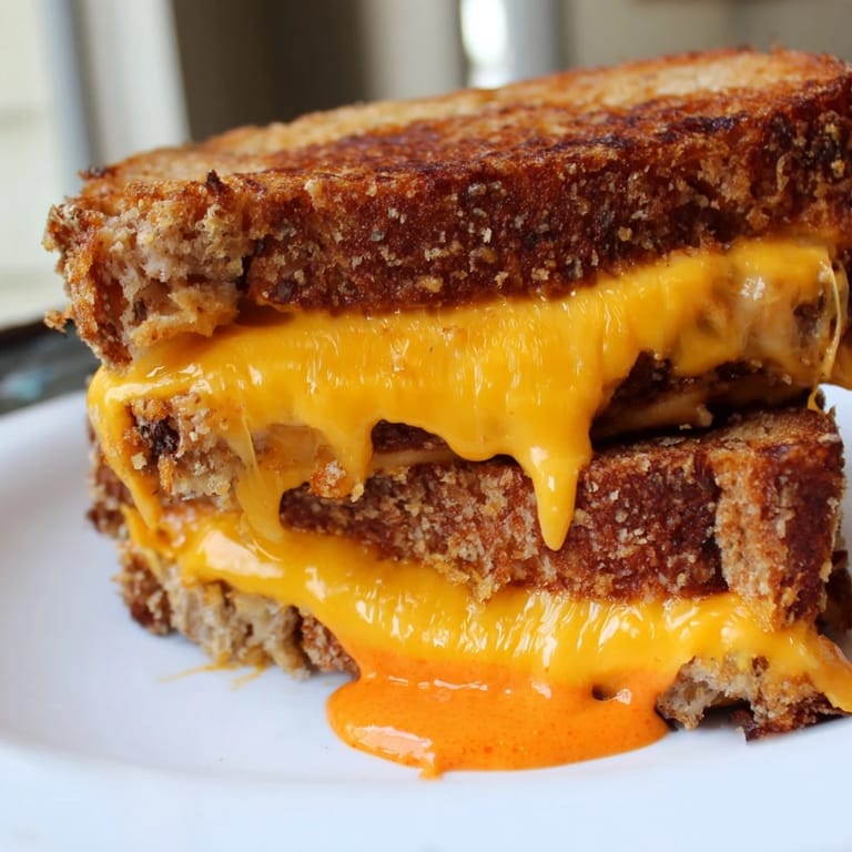 Crispy sourdough cradles melted cheese in this Spiked Grilled Cheese, enhanced by a spicy sriracha mayo.