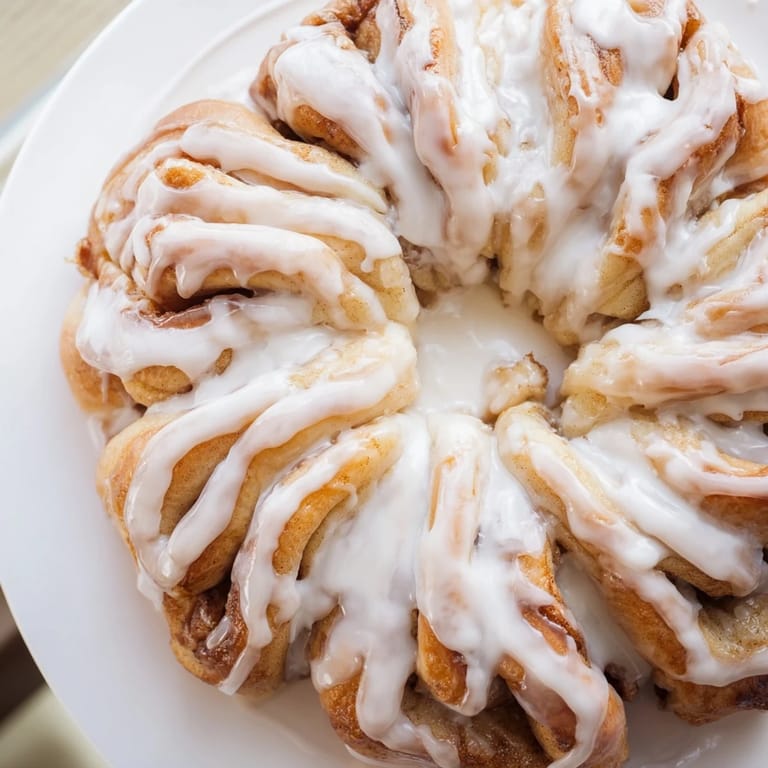 Freshly baked Cinnamon Roll Pull-Apart Snowflake, perfect for a cozy winter gathering, smelling so delicious.