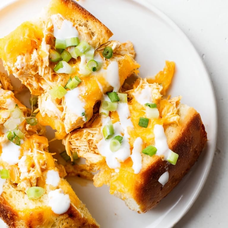 A Buffalo Chicken Ranch Grilled Cheese sandwich served with celery sticks and ranch dressing on the side for dipping.