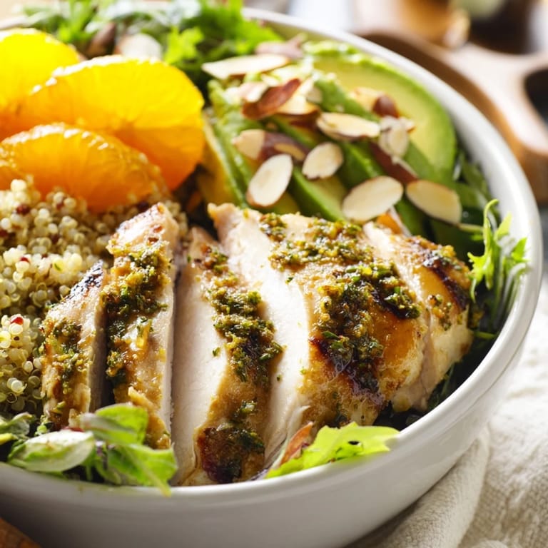 Citrus Herb Chicken Salad Bowl with creamy avocado, red onion, and toasted almonds in a vibrant, fresh arrangement.  
